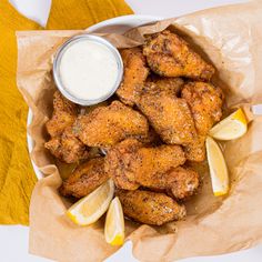 chicken wings with lemon wedges and ranch dressing