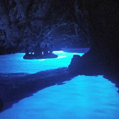 the water is glowing blue in this cave