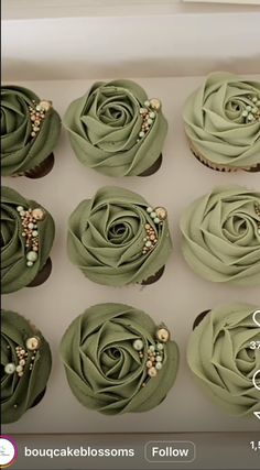 twelve cupcakes in a box with green frosting and beaded decorations on them