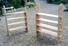 two wooden bookshelves sitting next to each other on a cobblestone road