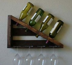 several wine glasses are hanging on a shelf