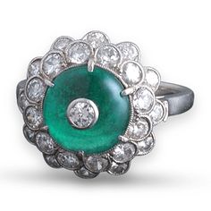 This wonderfully verdant, 3.00-carat cabochon emerald is crowned by a beautiful diamond in this Art Deco-period ring. The diamonds, which weigh a combined 1.00 carat, add the perfect amount of shimmer to this classic ring. Platinum. Carat weights are approximate. Jewelry Emerald, Vintage Art Deco Rings, Art Deco Diamond Rings, Deco Jewelry, Art Deco Diamond, Fine Jewels, Emerald Jewelry, Unique Gemstones, Art Deco Ring