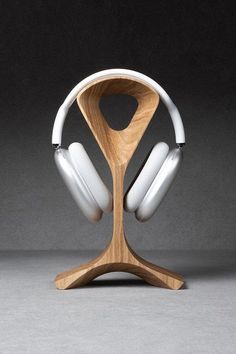 the headphones are on top of a wooden stand