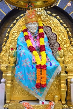 the statue is decorated with flowers and garlands