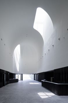 the interior of an empty building with sunlight coming in through the windows and shadows on the floor