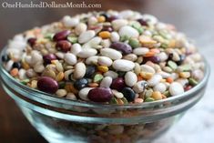 a glass bowl filled with beans on top of a table