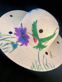 "Flat 4\" Brim Sun Hat Classic-round made from straw & paper braid, crushable, SPF 50 Protection Hand Painted Artwork - Painted to order NOTE:  Flower is included and is detachable - Pinned in place. Acrylic Paints used in artwork will not bleed if wet. See image in pictures section for sizing instructions.   NOTE:  HAT IS LARGE (59cm:23inch) INNER DIAMETER.   Adjustable Elastic Tie inside hat. Please allow for delivery times of 3-10 days as these are made to order. No refunds or exchanges but p Whimsical Adjustable Sun Hat With Curved Brim, Whimsical Sun Hat With Adjustable Curved Brim, Adjustable Whimsical Sun Hat With Curved Brim, Whimsical Adjustable Brimmed Sun Hat, Whimsical Sun Hat With Curved Brim, Whimsical Adjustable Sun Hat With Short Brim, Whimsical Adjustable Short Brim Sun Hat, Handmade Adjustable Sun Hat For Garden Party, Handmade Adjustable Straw Hat For Garden Party