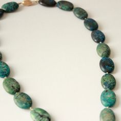 Often mistaken for turquoise, chrysocolla is a beautiful blue-green gem that resembles a tropical shoreline. This chrysocolla beaded necklace is a gorgeous statement piece that would be the perfect accent for any Spring/Summer look. We only have one! This style is one of a kind and ready to ship. This listing is for the pendant only. Crafted in San Francisco with ethically sourced materials. *All sales are final* Elegant Handmade Turquoise Chrysocolla Necklace, Artisan Chrysocolla Jewelry With Polished Beads, Elegant Oval Chrysocolla Necklace, Turquoise Chrysocolla Gemstone Necklace, Chrysocolla Gemstone Beads Jewelry For Healing, Oval Chrysocolla Necklace With Natural Stones, Elegant Turquoise Chrysocolla Necklace, Turquoise Chrysocolla Round Beads Necklace, Turquoise Chrysocolla Necklace With Round Beads