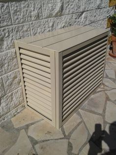 a large white box sitting on top of a stone floor