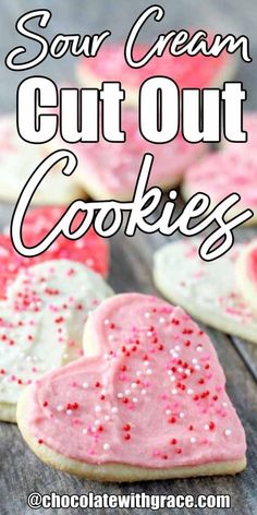 some heart shaped cookies with pink icing and sprinkles in the middle