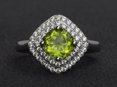 Welcome to my shop, you can find many beautiful gemstone jewelry here, and you also can ask for customized service. Main Stone: natural peridot, round cut 7X7mm, 1.39 carats.Accent Stones: cz Metal: 925 sterling silver plated with rhodium so as to protect the ring from tarnish and keep it shinning. I also can provide metal options such as 14k solid yellow/white/rose goldSetting: prong setting more rings: https://www.etsy.com/shop/XCjewelryStudio?ref=hdr_shop_menuIt's quite comfortable for wearin Green Cubic Zirconia Diamond Ring With Halo Design, Wedding Jewelry With Peridot In Halo Setting, Green Halo Jewelry With Round Cut, Green Halo Round Cut Jewelry, Round Peridot Jewelry With Halo Setting, Green Diamond Ring With Halo, Green Round Cut Halo Ring, Green Halo Ring With Round Cut, Green Round Cut Halo Design Jewelry