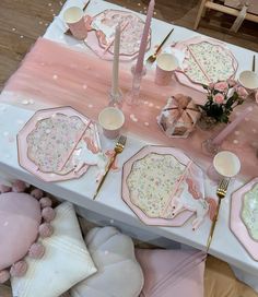 the table is set with pink and white plates