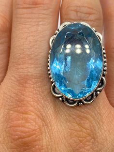 Large genuine aqua blue volcanic art glass Vintage ring Low content silver not sterling. Size 8 Our jeweler can re size this for a 20 fee.  All rings are shipped in a nice gift box.   Check out our over a THOUSAND great reviews Engraving is $4 per letter and is not always perfect depending on the piece. It can take a few days if the jeweler is busy. This is payable to Paypal Judithsltd@gmail.com Spiritual Blue Topaz Jewelry In Blue, Spiritual Blue Topaz Jewelry As A Gift, Spiritual Blue Crystal Gemstone Ring, Spiritual Blue Crystal Ring, Collectible Blue Topaz Blue Jewelry, Blue Topaz Jewelry Collectible, Turquoise Ring With Accent Stones For Gift, Spiritual Round Blue Topaz Jewelry, Round Turquoise Ring Perfect As A Gift