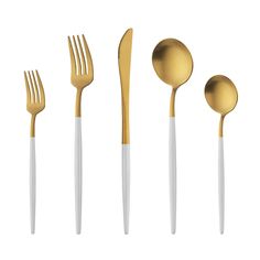 gold and white utensils are lined up in a row