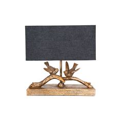 a lamp that is on top of a wooden base and has a black shade over it