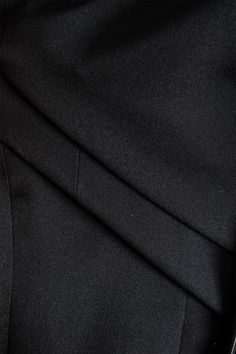 close up view of the lapel on a black suit