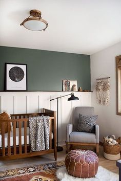 a baby's room with green walls and furniture