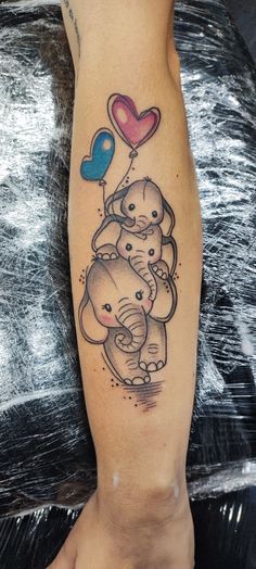 an elephant tattoo on the leg with balloons and heart shaped balloon in it's trunk