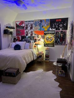 a bed room with a neatly made bed and pictures on the wall