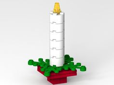 a lego model of a white tower with green plants on it's base and gold top