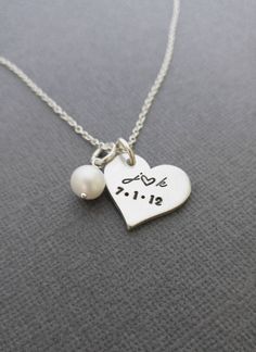 "« Personalized Necklace with Initials and Date // Anniversary Necklace // Hand Stamped Jewelry // Hand Stamped Necklace » Have this pretty heart pendant hand stamped with the initials and date of your choice to make the perfect gift! This necklace makes such a cute gift or keepsake and a cute way to carry a meaningful part of your life with you. The 3/4\" heart and freshwater pearl are hung from an 18\" oval link chain. Please let me know in the 'note to seller' box during checkout with the ini Dainty Stamped Charm Necklaces For Anniversary, Dainty Stamped Charm Necklace For Anniversary, Meaningful Heart-shaped Wedding Jewelry, Heart Charm Necklace For Anniversary, Personalized White Heart Necklace For Wedding, Dainty Stamped Necklace For Anniversary, Heart Necklace With Charms For Valentine's Day Wedding, Heart-shaped Wedding Necklaces, Valentine's Day Wedding Heart Necklace With Charms