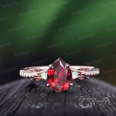 a close up view of a ring with a red stone