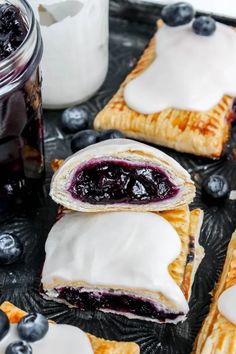 blueberry turnovers with white icing on a tray