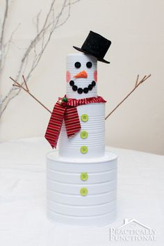 a snowman made out of cups sitting on top of a table