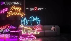 neon signs are lit up on the wall in a dark room with couches and tables