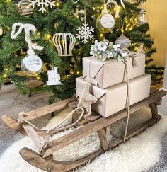 a sled with presents tied to it in front of a christmas tree