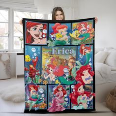 a woman is holding up a blanket with ariel and the little mermaids on it