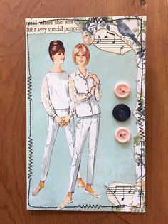 a card with two women in pajamas and buttons on it