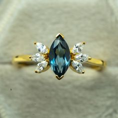 a gold ring with blue and white stones