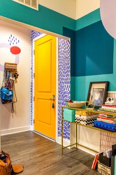 a brightly colored room with a yellow door