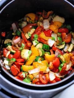 a pot filled with vegetables sitting on top of a stove