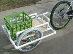 a bike with a cart attached to it on the street next to a bicycle tire