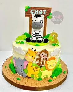 a birthday cake decorated with animals and the number three on it's top tier