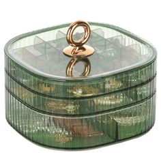 a green glass box with a gold ring on the top and two smaller boxes below it