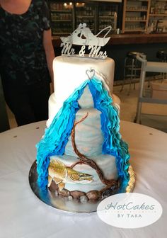 a white and blue cake sitting on top of a table