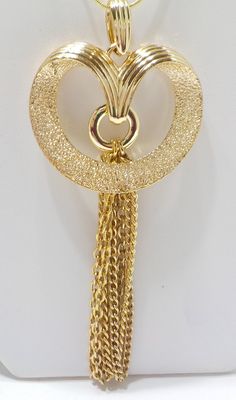 "Vintage gold tone Contempo tassel pendant necklace by Sarah Coventry. 18\" gold tone chain with a lobster claw fastener. Pendant is 3 1/2\"L including tassel, 1 3/4\" wide. There is some slight discoloring on the upper corner, and; this is not the original Coventry chain." Gold Tassel Dangle Necklace Gift, Gold Tassel Necklace With Fringe For Gift, Gold Tassel Necklace For Party, Gold Metal Tassel Dangle Necklace, Gold Metal Dangle Tassel Necklace, Gold Tassel Dangle Necklace, Gold Long Fringe Necklace, Funky Necklace, Sarah Coventry