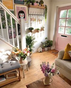 a living room filled with furniture and lots of plants