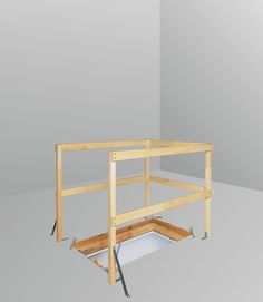 an unfinished bed frame is shown with the bottom section removed from it's side