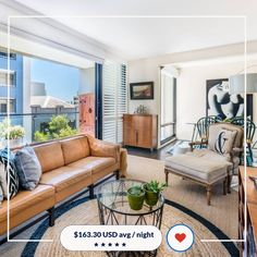 a living room filled with furniture and windows