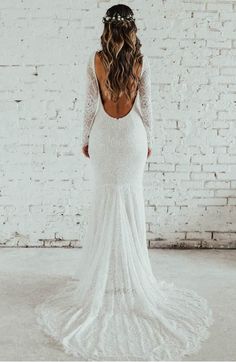 the back of a woman's wedding dress with long sleeves