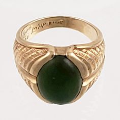 "This striking 14K gold ring features a large green jade stone and an engraved band that resembles a stylized fern or feather. Just the right combination of style and masculinity! Note that the inside of this ring has a lovers inscription and date 1974. Style: Classic, Masculine Vintage: 1970s Materials: 14K Gold, Green Jade Size: 10 Green Jade: 16mm x 12mm Width North to South: approx. 3/4\" Weight: 7.5 dwt / 11.6 g Condition: Very Good ASK ABOUT OUR FREE LAYAWAY! FREE FULLY INSURED PRIORITY SH Antique Green Emerald Ring With Polished Finish, Antique Green Rings With Polished Finish, Vintage Green Signet Ring With Polished Finish, Collectible Green Emerald Ring In 14k Gold, Vintage Green 14k Gold Signet Ring, Green 14k Gold Emerald Ring Collectible, Collectible 14k Gold Emerald Ring, Formal Green Engraved Signet Ring, Classic Green Engraved Signet Ring