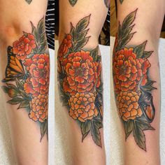 the legs are covered in tattoos with flowers and butterflies on them as well as an orange flower