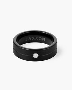 a black ring with a diamond in the center and an inscription on it that says jaxon