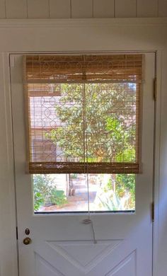 a white door with a window and blinds on it