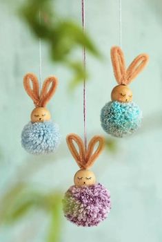 three small stuffed animals hanging from strings