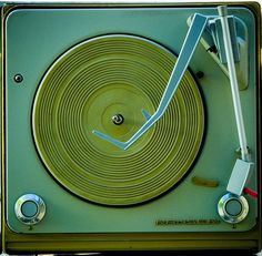 an old fashioned record player with the clock on it